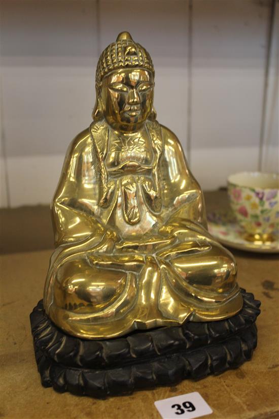 Thai brass figure of a seated Buddha, on hardwood base